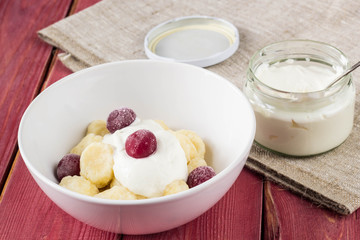 Traditional russian, ukrainian cottage cheese lazy dumplings served with sour cream and cherry