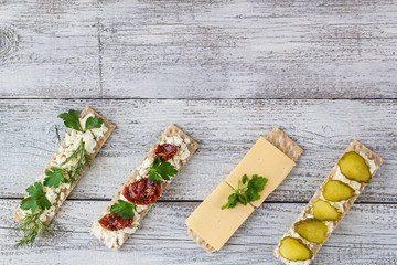 various crispbread slices on woden kitchen table, top view
