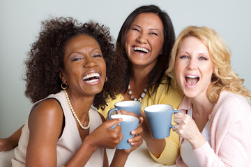 Diverse group of women talking and drinking coffee.