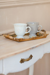Two cups of coffee on a vintage tray