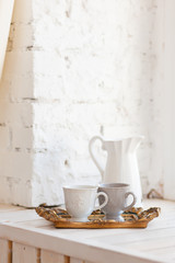 Two cups of coffee on a vintage tray