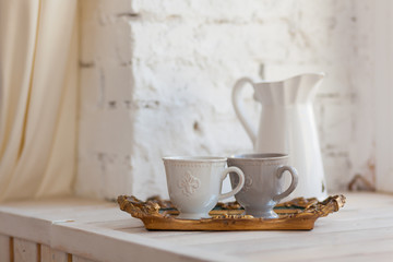 Two cups of coffee on a vintage tray