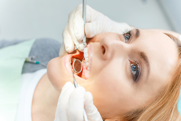 Close-up partial view of blonde woman at dental check up looking up