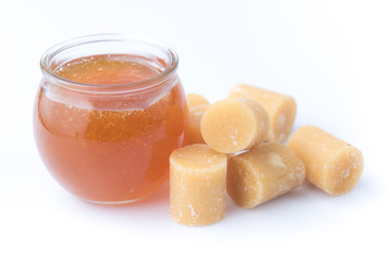Coconut sugar and sugar syrup in glass bowl on white background