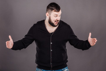 man holding two hands in front of him and shows the size on white isolated background in studio.