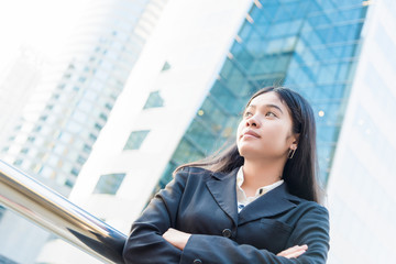 Head and shoulders portrait of smiling Asian businesswoman