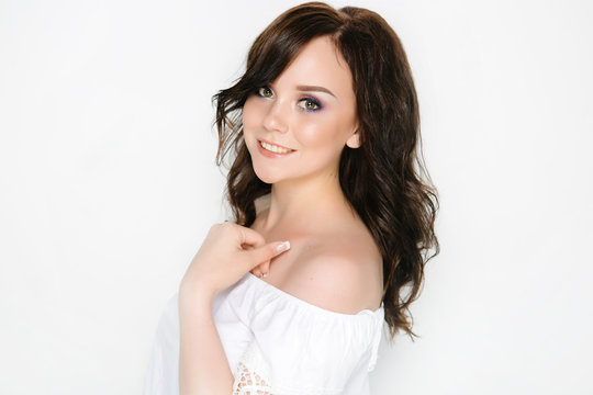 Cheerful young brunette girl with permanent make-up, isolated on white background
