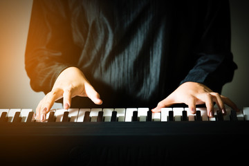 closeup hand of woman playing piano