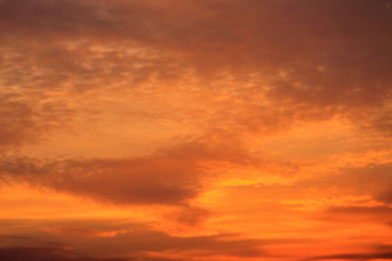 Naklejka na ściany i meble Fiery orange cloudy sky at sunset