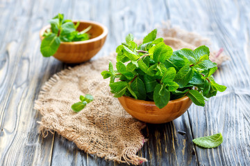 Fresh aromatic mint in a wooden bowl.