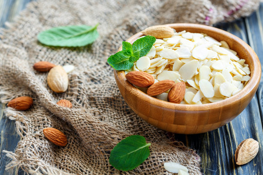 Almond flakes,whole almonds and mint in a bowl.