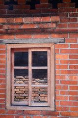 Window with wooden frames on brick wall