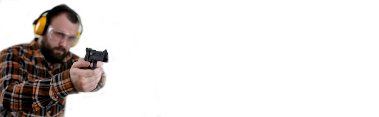 man with put on protective goggles and ear training in pistol sh