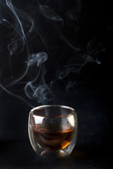 brandy in glass on dark background