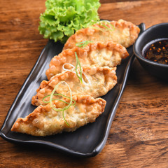 Gyoza with vegetable on wooden table