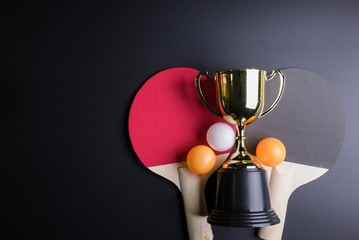 Golden trophy, Racket table tennis with ping pong ball on black background.Sport concept, Concept winner, Copy space image for your text.