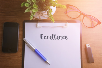 Fototapeta premium Business concept - Top view notebook writing Excellence.