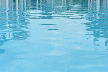 Blue pool water with sun reflections