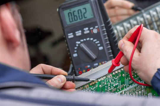 Checking circuit by Multimeter. Electrical engineer on during checking circuit board unit by Multimeter.