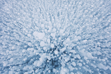 Bubbles texture in ice of Baikal lake. Winter background