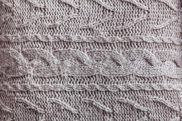 Beautiful gray knitted pattern, knitted scarf close up. Knitted background