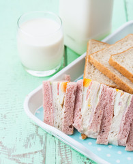 Fresh milk and bread sandwich on wooden table