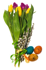 Composition of hand painted Easter eggs, flowers, catkins, daffodils tulips.