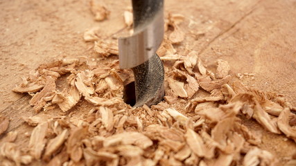 wood drill a wooden board with chips