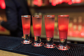Four cocktails in red standing in a row