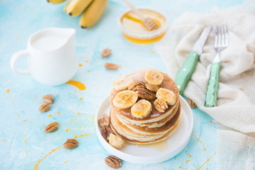 The American pancakes with honey, bananas and nuts
