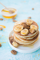 The American pancakes with honey, bananas and nuts
