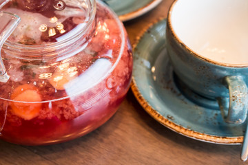 Empty cup for tea and teapot with tea, closeup
