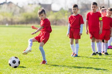 Kids soccer football - children players exercising before match on soccer field