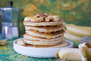 The American pancakes with honey, bananas and nuts
