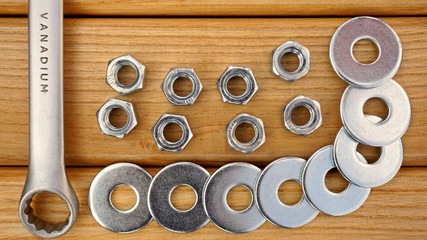 spanner nut and washers on a wooden background