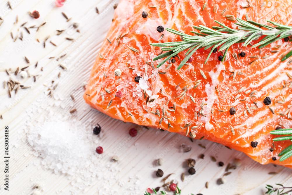 Wall mural salmon filet on a wooden carving board.