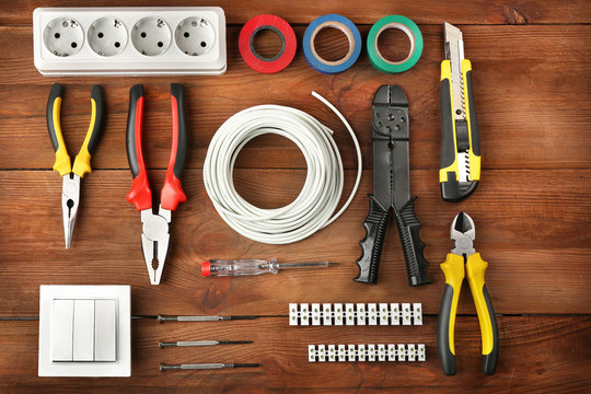 Different electrical tools on wooden table