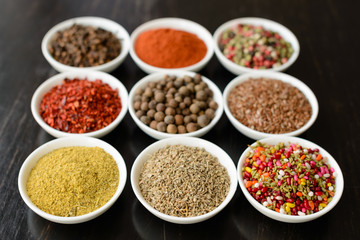 Various spices on wooden spoons. Food ingredients