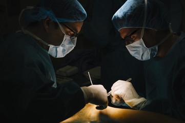 Surgeons making an Achilles tendon operation