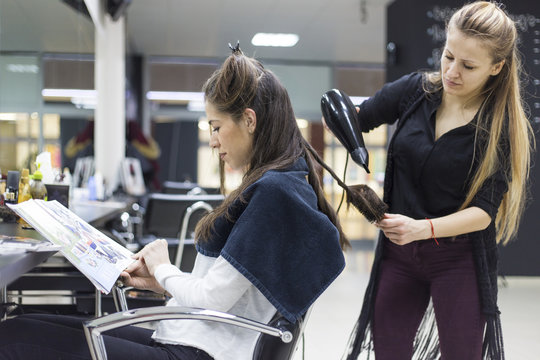 Beautiful women in hair salon doing her hair style