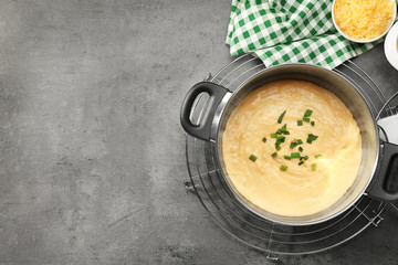 Saucepan with beer cheese dip on table