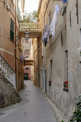 Fototapeta na wymiar drying laundry and narrow lane, Finalborgo, Italy