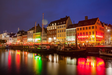 COPENHAGEN, DENMARK - 25 JUN 2016: Fairytale Nyhavn canal at blue hour, illuminated houses and street
