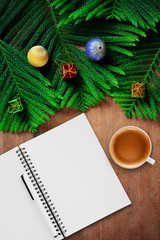 Cup of coffee and christmas background on wooden table.