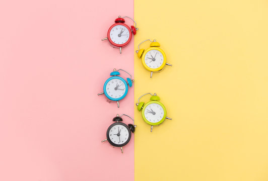 photo of colorful alarm clocks on the wonderful background in pop art style