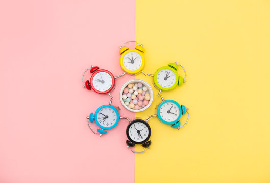 photo of colorful alarm clocks and powder on the wonderful background in pop art style