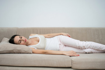Obraz na płótnie Canvas Woman sleeping on couch