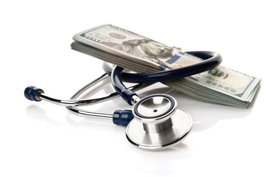 A stethoscope and American money on a white background - Healthcare cost concept