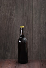 bottle of beer on a wooden background