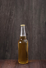bottle of beer on a wooden background